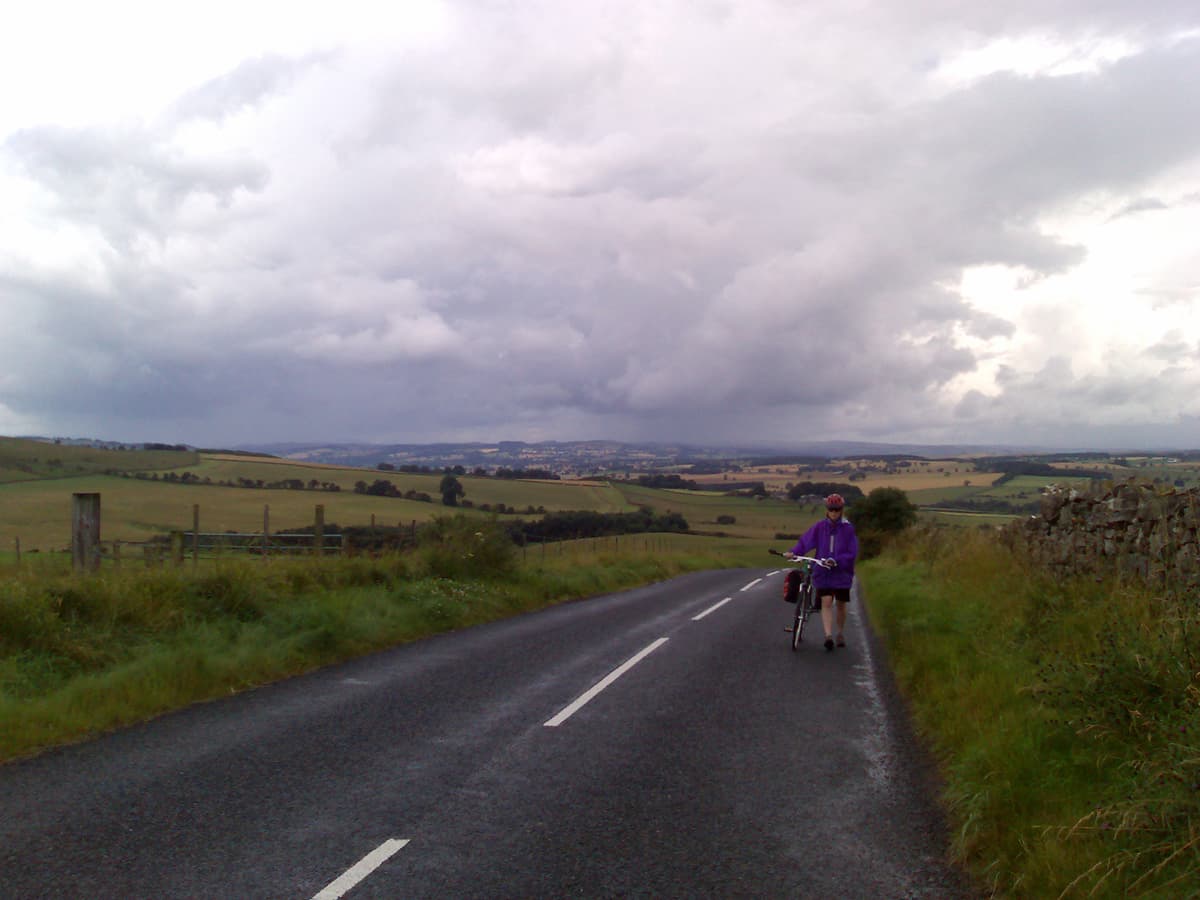 This was payback time for the 68km/hr descent on the way out, we had to climb back up the hill.  Neither of us could make it cycling and we ended up having to push.<p>Pips wasn't too happy, the weather had turned nasty and it had already rained a couple of times but we weren't yet as wet as we were going to be later.<p>Oh, and to add insult to injury, I had a small swarm of flies that were buzzing around my head and landing on me and since I was walking I couldn't outpace them.  Strangely Pippa had none but didn't see this as worthy of celebration ;-)