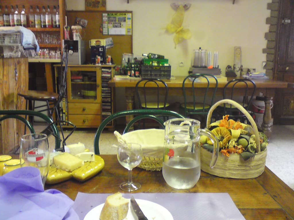 12.19pm  This was where I had lunch, Restaurant D'O, in a small town called Job, about 10km short of the place where I was to camp.  <p>It was the nicest lunch I was to have I think: a lovely salad that looked like a work of art, and Osso Bucco with Pommes Boulangere for the main course.  The first time I'd had it and it was fantastic.  Followed by a plate of cheeses and then a chocolate mouse.<p>The place was delightful, the man was a bit of a slob but the woman was dressed, unusually, but with style and attention to detail and colour.  When I looked around I noticed that the same attention was lent to everything.  The salad, the bottles of sirop, the hand-painted frieze around the walls, the dried flower decorations on the table and, of course, the food.<p>For dinner I had a picnic, thanks to the local supermarket, of Rose wine, Rillette de oie, toms, avocado, olives and bread.