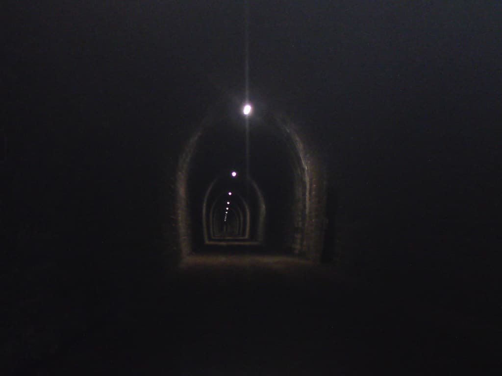 Cool they were but also very, very long - once in you couldn't see either end, and, though lit, there were gaps in the light so you had 10m or so of pitch black to take your chances with in between each light.  The ground was gravel and stones, with puddles so it made for an interesting ride.