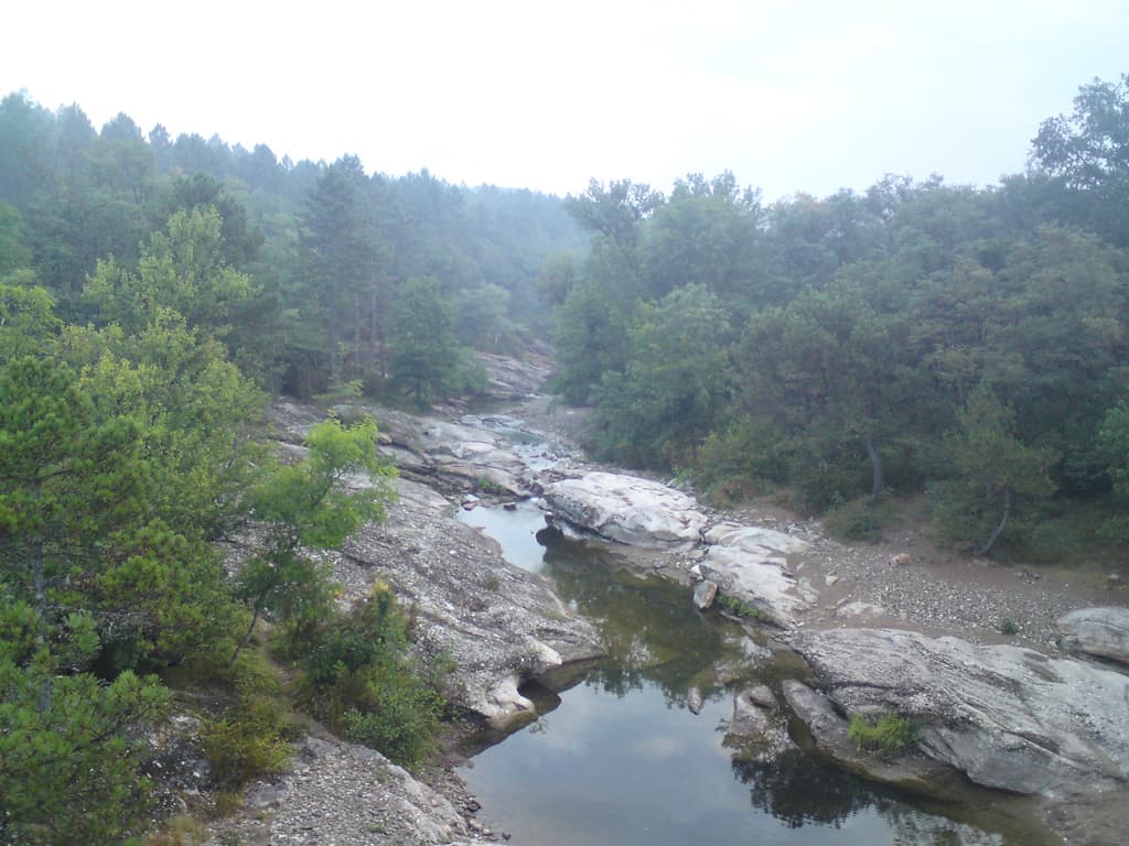 6.10am  The first few km were a steepish ascent up onto a plateau but then after that it was a level or slight descent through a rocky, forested landscape with almost no one around.  When I got the camera out to take this photo a crane or stork that had been just in the pool you see flew off and my camera/phone was too slow loading to get it.