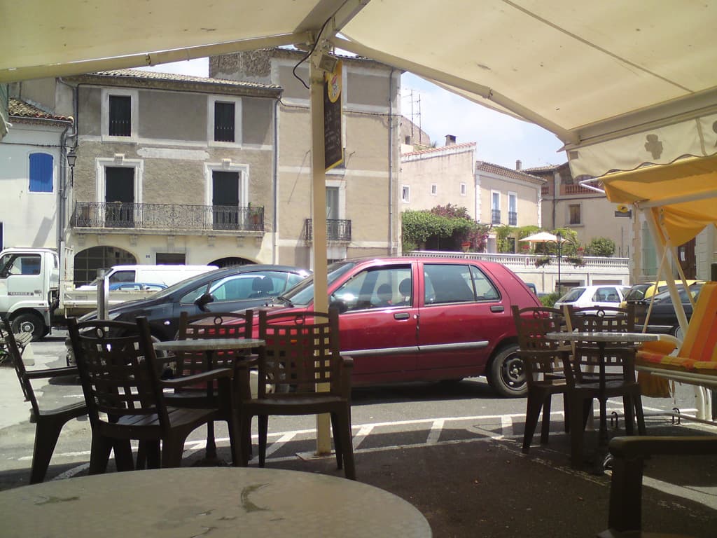 <p>I'd thought the entire town was closed, not a soul in the streets.  I'd gone into a shop to ask if they could fill my water bottle and you'd think I'd asked to drink the fresh blood of their first born; the first time I'd been anything other than happily received.  Finally, I found a small restaurant in the centre of the village and had a good lunch: a very tasty fish soup, marmite (a creamy fish pie with flaky pastry top), with a small carafe of ros&eacute;  Well I felt I'd suffered enough.  This is the view from their terrace umbrella, where I sat on a swing seat to let my lunch go down before riding off again.</p>