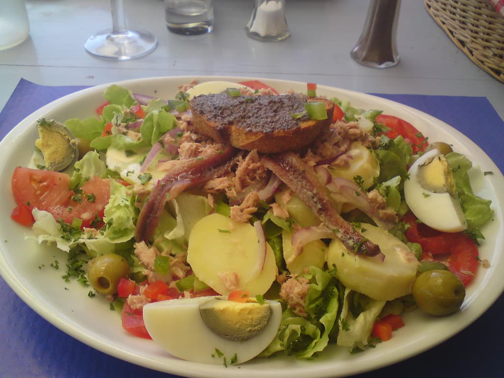 12.58am  I had Salad Ni&ccedil;oise followed by a very nice wood fired oven cooked pizza, with, yes you guessed it, chilled ros&eacute;.  It was fantastic.<p>I'd got the rest of the day free, since I'd finished surprisingly early in spite of the long ride, and so I went to have a swim and sunbathe; after putting up the tent and doing my washing that is.<p>After an hour or so the pool filled up with noisy kids so I wandered off to visit Tuchan, since I'd come in the back way and hadn't yet seen the centre.<p>The town was having some fete day celebrating the local wine - so I listened to an early music folk band in the town square, tasted 20 different honey's and bought some thyme honey.<p>For dinner I had cassoulet de magret and felt full.  I fed sparrows with fat chicks and watched swallows against a blue sky.