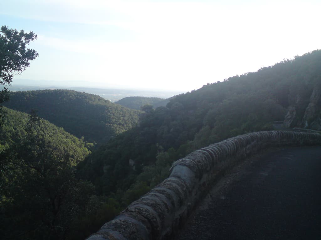 6.59am  It wasn't too steep but it was long.  Long, curving, small lanes with high cliffs on one side and precipitous falls on the other.  This was a view back down part of the way up.<p>At one point I remember seeing some houses on the hill/mountain opposite and wondering how the hell they got to their houses.  An hour later when I was cycling past them I found out - roads in mountains curve around a lot.