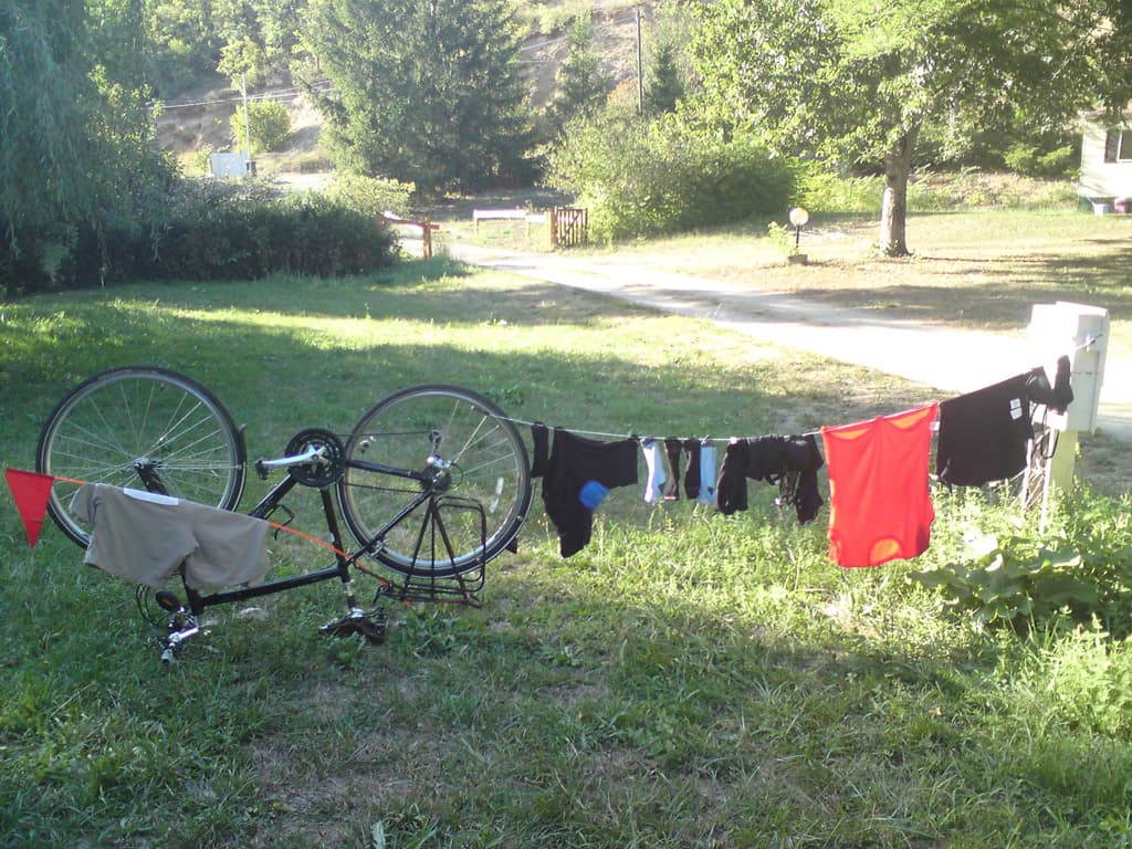 I was quite pleased with this setup, I'd hung the curly washing line thingy onto the electricity output at one end and needed somewhere to hang at the other. <p>Enter the upside-down-bike-solution, worked at treat.  Worked a treat until we needed to go out for dinner that is.  But my inventiveness knew no bounds.  Whipping out my Swiss Army Knife I whittled a dead branch of a tree into a point and pushed it into the ground at 45&deg;s and attached the washing line to that.  Also worked a treat.