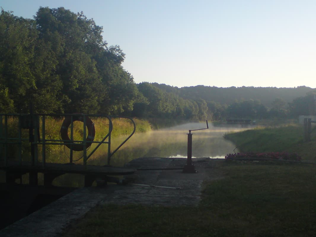 <p>Sometimes, on early starts, the canal would have a light covering of mist and, except for bird-song, be utterly silent except for the crunch of my wheels on the gravel outside the lock-keepers' houses.</p>