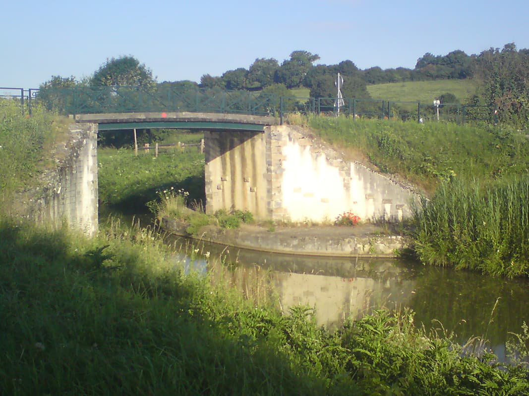 <p>I'm getting close to Decize and the end of the Canal du Nivernais, it's been a really nice two day's of easy riding.&nbsp; I managed to get lost in Decize in spite of the GPS, and then missed the turning after Decize too, simply because I couldn't believe the dirt track, through some gates next to a gatehouse, was the right turnoff.&nbsp; In fact it was my day for missing turnings.&nbsp; I flew past two heavily laden german tourists only to be caught up by them 20 minutes later because I was having to cycle back the way I'd come.&nbsp; Hare and the tortoise.</p><p>I was cycling along some lovely little roads
 with very few people around.&nbsp; I was a delight in fact to be off the canal.&nbsp; As nice as the canal was it is easy to end up just following it and not seeing much else.&nbsp; Roads were more interesting, you were alway's passing something and the scenery changed more frequently.</p><p>Unfortunately, the roads were so quiet and the temperature was rising and I was starting to think I was just not going to find anywhere to eat when suddenly there was a restaurant by the side of the road.&nbsp;
 With a menu for 12&euro;.&nbsp; Duck pat&eacute;
 with salad followed by a very good boeuf borguignon and potato gratin, then fromage blanc, water and wine, couldn't manage the desert that was also included in the price, too full.</p><p>There didn't seem to be any campsites nearby though I'd noticed that there was one in St Pierre.&nbsp; Took a bit of getting to if I wanted to miss the large main roads but I managed of course.</p><p>Quite a nice little town which needed what seemed like a large detour at the end of the day to skirt around the railway line.&nbsp; Went to the post office to post the maps and info on the Nivernais I'd accumulated.&nbsp; A nice french girl who spoke English helped
 with postal advice.</p>