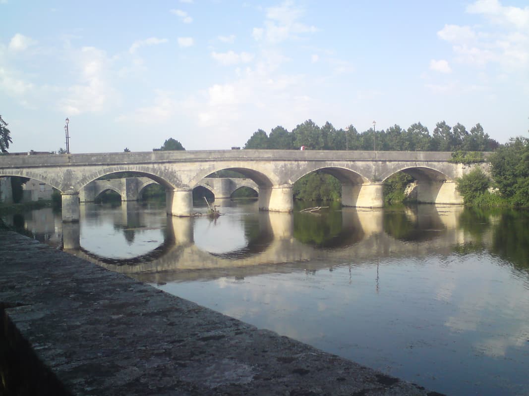 <p>There was a tree lined boule area just next to the Abbey
 with this view of two arched bridges over the river Gartempe.</p><p>I turned to ride back and bumped into a group of lads who were interested in my bike.&nbsp; It turned out that one of them had designed and built his own mountain bike who was more than interested in how my Challenge Mistral was made.</p>