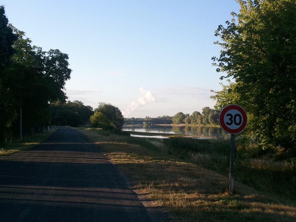 <p><strong>Monday 11th July. Briare to La Charit&eacute; sur Loire: 75km, avg 17.3km/hr, max 41km/hr</strong></p><p>If you rollover this image you'll see a different one, clicking shows the same one but larger. &nbsp;It was the most lovely morning as you can perhaps tell. &nbsp;The sun, being low in the sky, casts long shadows that highlight everything bathes it in a warm golden light. &nbsp;This was the Loire flowing quietly past, just in front of the campsite.</p>