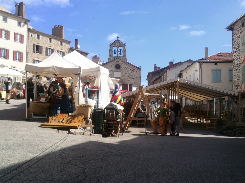 <p>Lots, I mean lots of people where dressed up in medieval garb and this group were cooking. &nbsp;Cooking for us tourists but also for all the other musicians, jugglers and stall holders who were creating the fete. &nbsp;They were cooking here using traditional medieval cooking methods. &nbsp;I had asked if the recipe included ear of donkey and skin of toad but they assured me that it didn't. &nbsp;I don't think I'd have minded, it smelled wonderful.</p><p>If you click on this photo the larger one is of a view back up the hill into the village and shows the stalls laid out.</p>