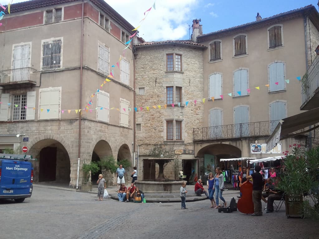 <p>I went for a wander around Les Vans, firstly to take all of my clothes to the launderette. &nbsp;Although I wash what I'm wearing every day I thought it'd be good to wash with powder in a machine rather than with my travel soap and by hand. &nbsp;I also tried to buy another small notebook, I'd actually bought the one that I currently have, almost full now, the last time I was here, two years ago. &nbsp;Unfortunately they didn't have one in the size I wanted.</p><p>Les Vans is quite a nice town, a bit touristy but nice for all that. &nbsp;This square had stalls of various sorts out later in the evening and this group of musicians where still playing.</p>