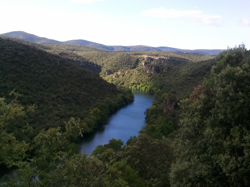 <p>It's a nice ride, though hilly, and after a very pleasant ride, largly flat, following the river, things start to go uphill. &nbsp;It was now also much hotter, so much so that if the road was straight so that I could see what little traffic might be coming I'd cycle on the left where it was shadier.</p><p>Actually at Causse de la Selle you have a choice, you can take a steeper option to follow the valley of Bu&egrave;ges, which I'd thought about doing but then decided not to. &nbsp;In part because I was tired and am naturally lazy but in part also because I missed the turning.</p><p>There is a rollover image to this photo showing some canoists enjoying themselves.</p><p>The road takes you through St Guillem le Desert, which is meant to be a lovely site worth stopping at but it alway's seems full of tourists, at the least the twice I've cycled through and so that's what I do: cycle through.</p>