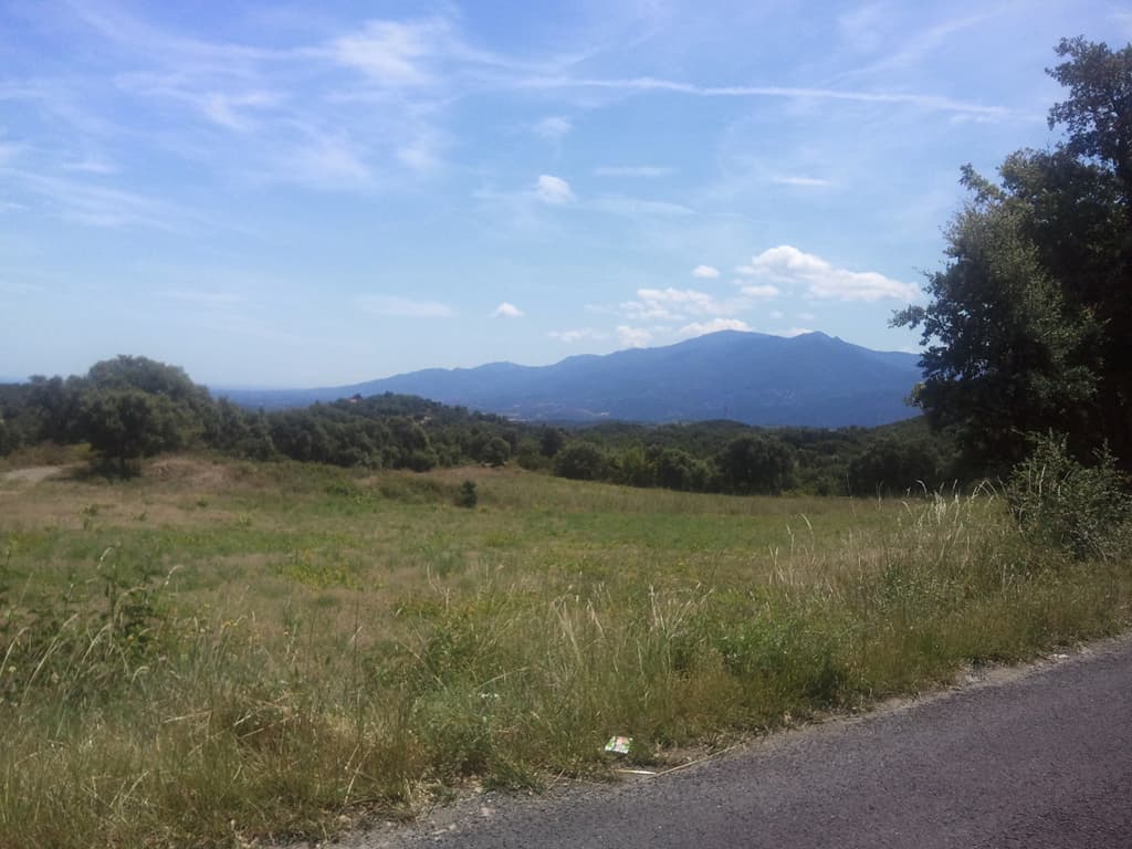 <p>The ascent to here was endless, steep mountain road with curves up through pine and holm oak woods, and very hot too. &nbsp;I was so glad to get to this point and the almost 10km of descent to St Jean Pla de Corts, which I took slowly and savoured, was great with views of the Pyrenees and the sea. &nbsp;</p><p>Click on this small thumbnail picture to see a larger one of a different view.</p>