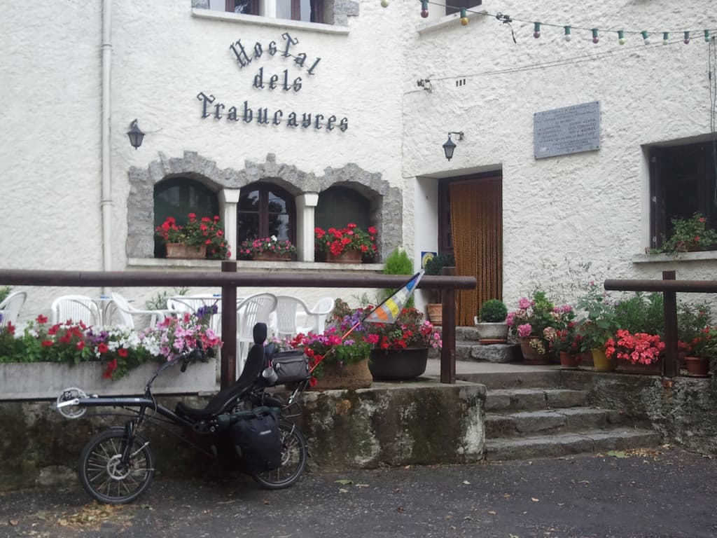 <p>This is the village almost at the top. &nbsp;I'd not actually bothered going the short distance into the village the last time I passed this way but today I thought I'd explore, and stop for a coffee.</p><p>This place apparently does very good food, though it's only about 9.15am so I'm a bit early for that. &nbsp;I was dripping wet though, sweat though, not rain.</p><p>The next part is the lovely little pass that is really a footpath, very Gregory Peck escapes the Boche. &nbsp;A rock with a french flag and a rock with a spanish flag to indicate the border.</p>