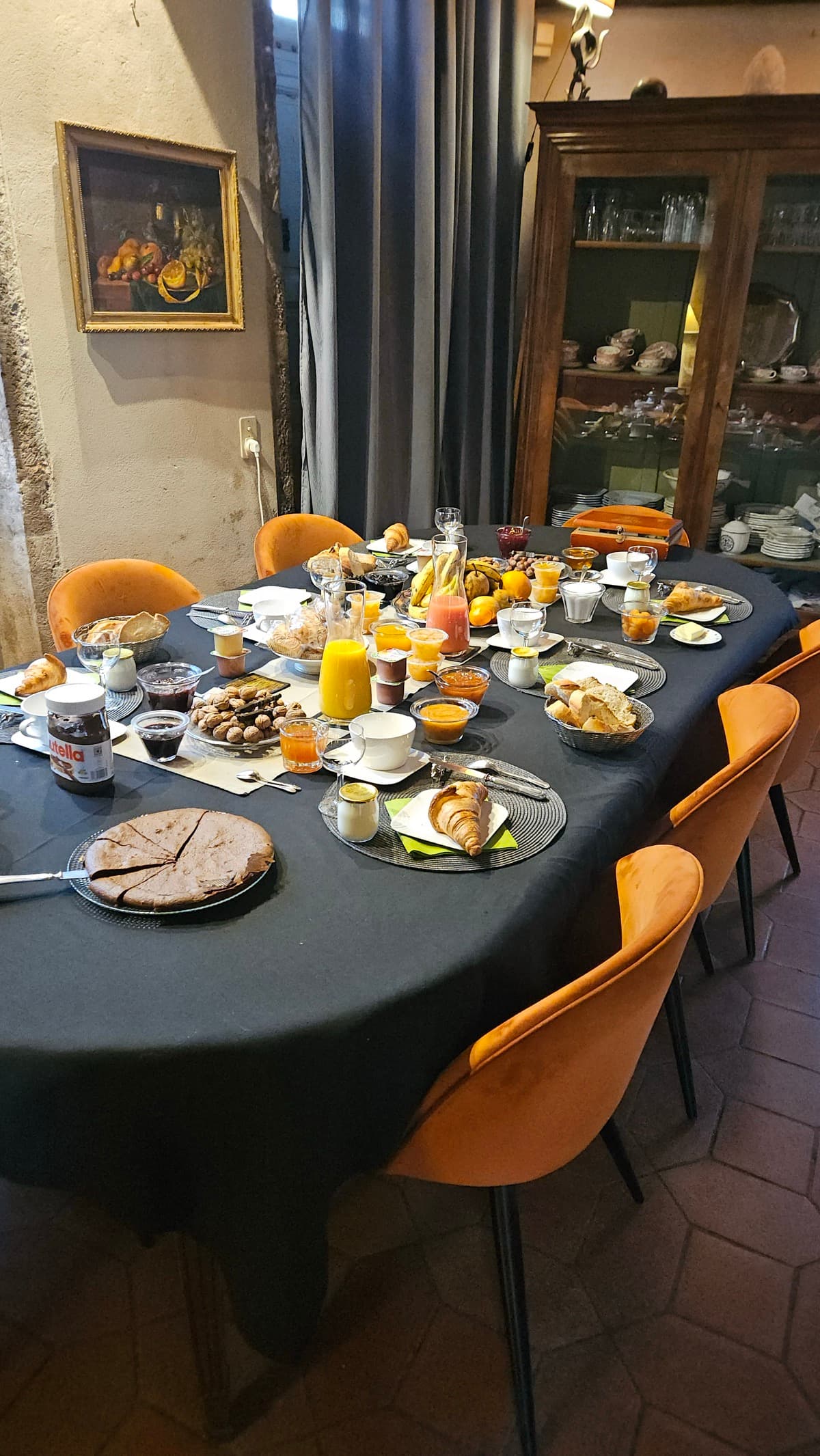 OK, now we're off to Cluny where we're booked in at La Maison des Gardes.  As you can see from the groaning breakfast table, it was a <b>wonderful</b> place.  They have a huge garden with very tall mature trees.  All the rooms are decorated beautifully with sensitive regard for the antiquity of the building.  If I remember correctly it's been in the family for a number of generations.
<p>In fact we very much liked Cluny overall, some great shops, old bars, antique shops, churches, an abbey, a river and parks.  We're planning on going back.</p>