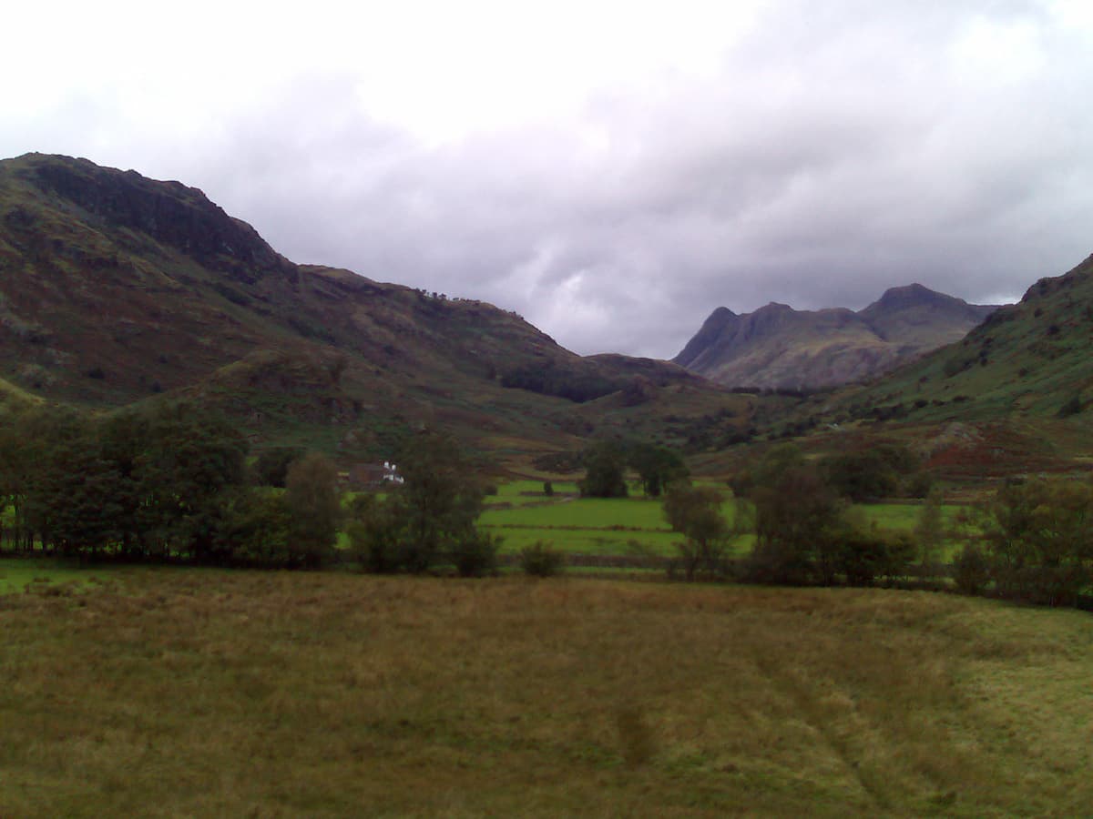 As we start to gain a bit of height you can make out the Pike o' Stickle, Loft Crag, and Harrison Stickle quite clearly.  You can also see the white farm buildings of Low Foot Farm.